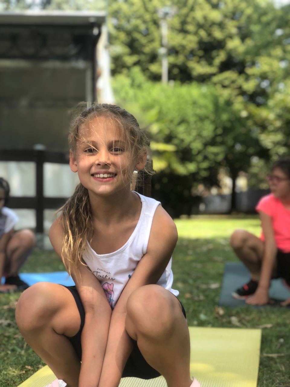 Bambina che si allena sul tappetino di acrobatica